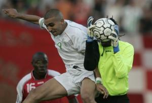 Gambia's goalkeeper Misa Bataha (R) saves a shot by