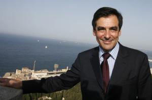 French Prime Minister Francois Fillon poses for photographs outside
