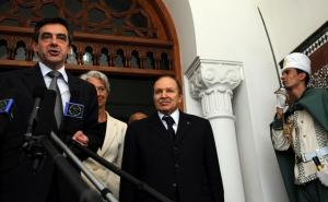 French Prime Minister Francois Fillon (L) speaks to the