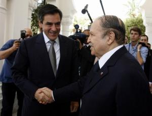Algeria's president Abdelaziz Bouteflika (R) shakes hands with French