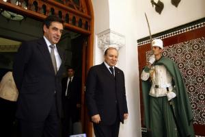 Algeria's President Abdelaziz Bouteflika (C) walks with French Prime