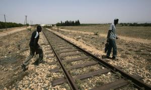 Would-be immigrants walk at the border between Morocco and