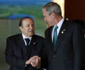 U.S. President George W. Bush (R) holds hands with