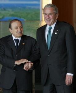 U.S. President George W. Bush (R) holds hands with