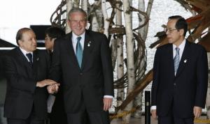 Algeria's President Abdelaziz Bouteflika (L) shares a light moment