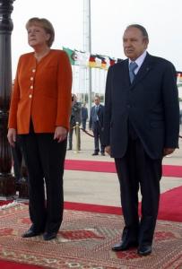 Algerian President Abdelaziz Bouteflika (R) listens to the national