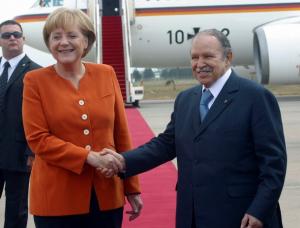 Algerian President Abdelaziz Bouteflika (R) shakes hands with German