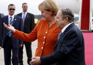 Algeria's President Abdelaziz Bouteflika (R) talks with German Chancellor