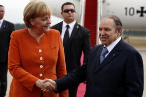 Algeria's President Abdelaziz Bouteflika shakes hands with German Chancellor