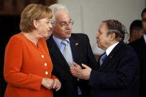 Algeria's President Abdelaziz Bouteflika (R) talks to German Chancellor