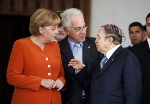 Algeria's President Abdelaziz Bouteflika (R) talks to German Chancellor