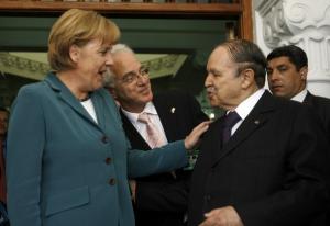German Chancellor Angela Merkel (L) talks with Algeria's President