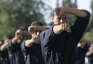 Newly graduated policemen take part in a ceremony to