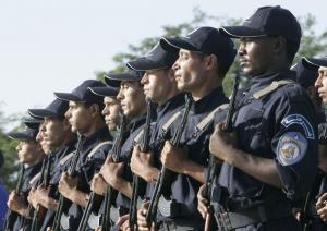 Newly graduated policemen take part in a ceremony to