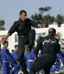 Newly graduated policemen demonstrate their karate skills during a