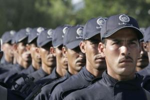 Newly graduated policemen take part in a ceremony to