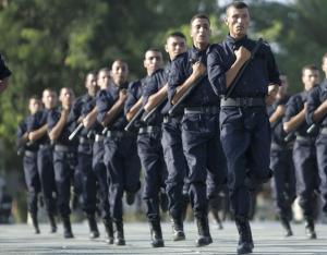 Newly graduated policemen take part in a ceremony to