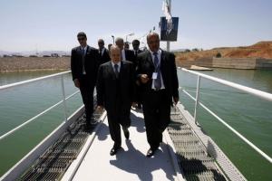 Algeria's President Abdelaziz Bouteflika (L) inspects after he inaugurated