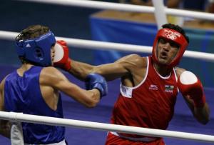 Dinesh Kumar (R) of India fights Abdelhafid Benchabla of