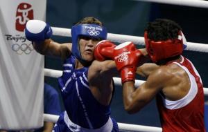 Dinesh Kumar (R) of India fights Abdelhafid Benchabla of
