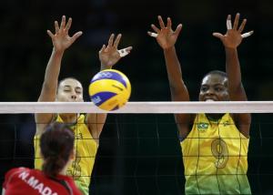 Algeria's Narimene Madani spikes against Brazil's Sheilla Castro and