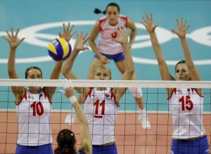 Kazakhstan's Yelena Pavlova spikes against Serbia's Maja Ognjenovic (LtoR),
