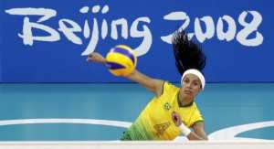 Paula Pequeno of Brazil serves against Algeria during their