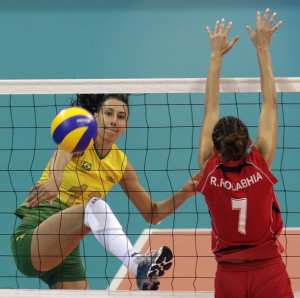 Sheilla Castro (L) of Brazil spikes the ball against