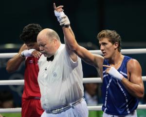 Algeria's Abdelhafid Benchabla (R) is declared winner after defeating