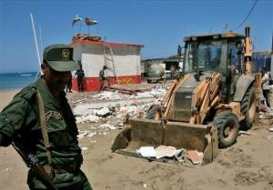 A mechanical shovel removes the debris, Sunday, Aug. 10,