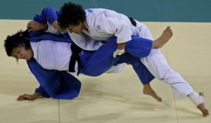 Soraya Haddad of Algeria (white) fights with Sholpan Kaliyeva