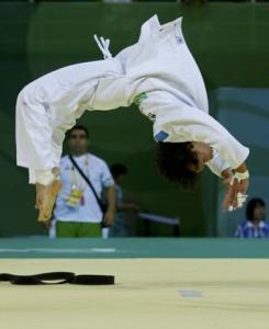 Soraya Haddad of Algeria back flips after defeating Sholpan