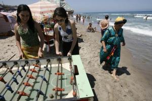 Women play a table football on the Little Paradise