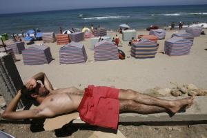 A man lies on  the Little Paradise beach