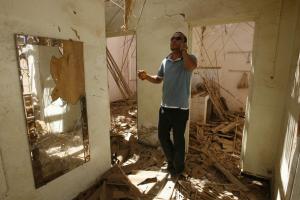 A man talks on the phone as he inspects