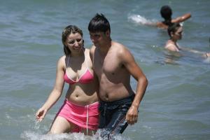 A couple enjoys the sea at Little Paradise beach