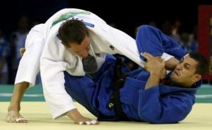 Amar Meridja of  Algeria (blue) fights with Konstantin