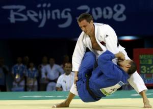 Amar Meridja of  Algeria (blue) fights with Konstantin