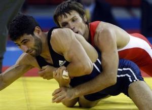 Germany's Konstantin Schneider, top, wraps Algeria's Messaoud Zeghdane during