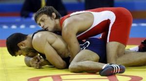 Germany's Konstantin Schneider, top, wraps Algeria's Messaoud Zeghdane during