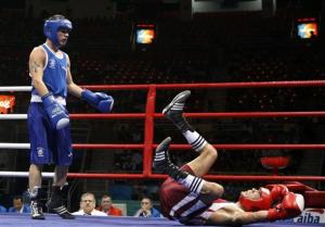 Abdelhalim Ourradi (R) of Algeria falls on the canvas