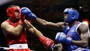 Abdelaziz Touilbini (L) of Algeria fights Deontay Wilder of