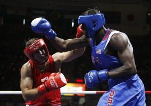 Abdelaziz Touilbini (L) of Algeria fights Deontay Wilder of