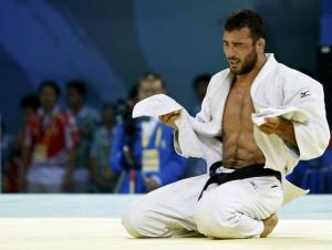 Amar Benikhlef of Algeria celebrates after defeating Yves-Matthieu Dafreville