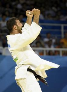 Algeria's Amar Benikhlef celebrates after winning his fight against
