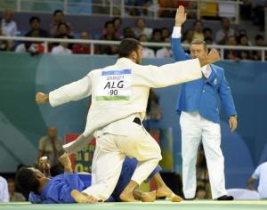 Algeria's Amar Benikhlef celebrates after winning his fight against