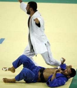 Algeria's Amar Benikhlef (top) celebrates after winning his fight