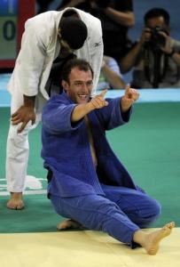 Georgia's Irakli Tsirekidze (bottom) celebrates after winning the gold