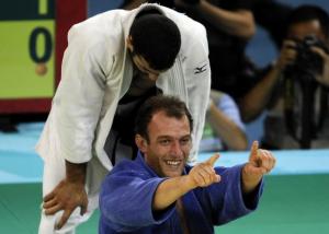 Georgia's Irakli Tsirekidze (bottom) celebrates after winning the gold