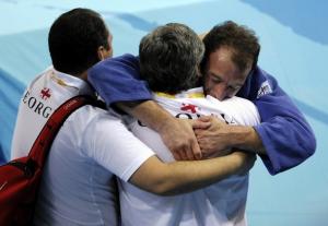 Georgia's Irakli Tsirekidze (R) celebrates with staff members after